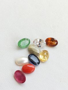 Stone : Natural and Precious ~ Ruby , Emerald , Coral , Yellow Sapphire , Blue Sapphire , Cat's Eye , Pearl , Hessonite , Zircon. Grade : AAA+ Size : 5x7 mm Shape : Oval (faceted, Except pearl, coral and cats eye) Color : Multi-Color Weight : 8.5 Gemstone are made in Billions of Years in the Womb of Earth. Gemstones connect us widely to the universe and spirits. All the photographs of the item are captured in natural daylight. The photographs are uploaded without any enhancements or editing. All Multicolor Oval Gemstones For Anniversary, Oval Multicolor Gemstones For Anniversary, Oval Multicolor Gemstones With Accents, Oval Multicolor Gemstones For Gift, Classic Faceted Oval Gemstones, Classic Oval Faceted Gemstones, Oval Multicolor Natural Stones Gemstones, Oval Gemstone Beads And Cabochons For Gifts, Oval Natural Stones For Jewelry Making