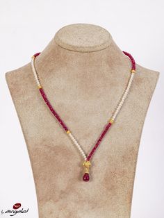 This exquisite handmade necklace features a stunning combination of ruby and freshwater pearl beads, strung together to create a piece that is both elegant and timeless. The lustrous pearls contrast beautifully with the deep red of the ruby, creating a unique and eye-catching piece of jewelry. Each bead has been carefully selected and handcrafted to ensure that this necklace is of the highest quality. This necklace is perfect for any occasion. It can be dressed up for a formal event or worn as a statement piece with a more casual outfit. Either way, this necklace is sure to make you stand out from the crowd and feel confident and beautiful. The combination of ruby and pearl is not only visually stunning but also has deep symbolic meaning. Ruby is said to represent passion and energy, while Elegant Red Pearl Necklace With Gemstone Beads, Elegant Red Pearl Necklace With Natural Stones, Elegant Single Strand Red Pearl Necklace, Red Elegant Pearl Drop Necklace, Elegant Red Pearl Drop Necklace, Elegant Red Single Strand Pearl Necklace, Elegant Ruby Necklaces With Natural Stones, Elegant Ruby Necklace With Natural Stones, Elegant Red Faceted Bead Pearl Necklace