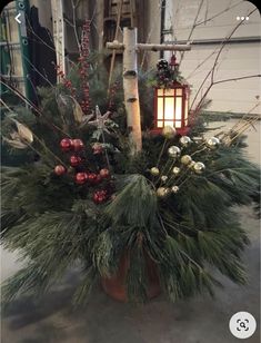 a christmas arrangement in a pot on the floor