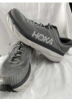 PRE-OWNED Elevate your running game with these Hoka One One Bondi 7 athletic shoes for men. The lace-up closure ensures a secure fit, while the gray color adds a stylish touch to your workout attire. The shoes are made with a mesh upper material for breathability and feature the Hoka One One Bondi 7 design for optimal performance during running and jogging activities. These shoes are 100% authentic Hoka One One brand and come in a standard shoe width. The size 14 US men's shoe size is perfect for those with larger feet. These running shoes are ideal for casual occasions and are perfect for any man looking to up his workout game. 7 Design, Workout Games, Workout Attire, Hoka One One, Men's Shoe, Athletic Running, Workout Shoes, Us Man, The Gray