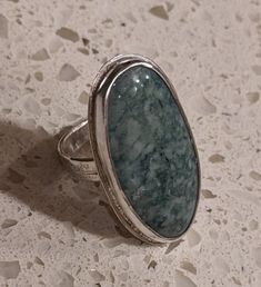 Guatemalan Jade Ring, original design. I created both the ring and the gem, a lovely green natural gemstone from Guatemala, set in sterling silver. 47mm x 20mm cabochon, size 8. Collectible Oval Cabochon Emerald Ring, Unique Oval Cabochon Emerald Ring, Unique Oval Emerald Ring With Polished Finish, Unique Jade Gemstone Ring, Green Agate Oval Rings, Handmade Oval Moss Agate Ring, Green Oval Agate Rings, Oval Agate Ring With Large Stone, Unique Oval Turquoise Ring For Formal Events