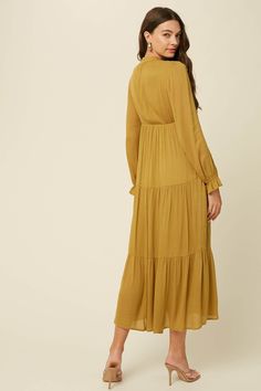 -Color: Green Mustard -Crinkle textured -Long sleeves with ruffle cuffs-Tiered skirt-Tie neck with self strap-Side seam pockets-Lined -Content: 100% Rayon -Hand wash/ Line dry -Imported -Runs true to size-Model is 5' 9" 31-24-35 and wearing a size Small Billowy Long Sleeve Midi Dress With Ruffle Hem, Daywear Maxi Dress With Ruffles In Viscose, Daywear Viscose Maxi Dress With Ruffles, Viscose Maxi Dress With Ruffles For Daywear, Flowy Ruffled Midi Dress For Work, Long Sleeve Ruffled Maxi Dress For Work, Tiered Maxi Dress, Tiered Skirt, Tie Neck