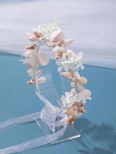 a headband with seashells and starfish is shown on a blue surface