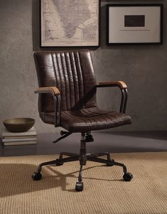 a brown leather office chair sitting on top of a carpeted floor next to a framed map