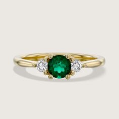 Luxurious and lavish, the Audrey ring is a mesmerizing assembly of a bold center green emerald in-between two regal accent white diamonds. This glamorous piece is perfect for any occasion, especially an engagement, and adds the flawless amount of sparkle to any look. A timeless piece that can be customized with any stones your heart desires. All features can be customized! Please contact us if you wish to make changes, we love making custom designs. All of our jewelry is carefully handmade in our atelier. *HC diamond are all conflict-free diamonds To order by phone 972-72-2991000 See In White Gold Yellow Gold Emerald Cluster Ring With Center Stone, Green Emerald-cut Cluster Ring With Diamond Accents, Timeless Emerald Diamond Ring In Yellow Gold, Timeless Yellow Gold Emerald Diamond Ring, Emerald Cut Green Cluster Ring With Diamond Accents, Timeless Yellow Gold Diamond Ring With Emerald, Classic Emerald Diamond Ring With Accent Stones, Green Emerald Ring With Diamond Accents For Promise, Green Emerald Promise Ring With Diamond Accents