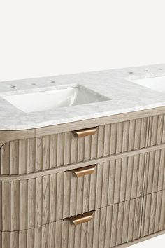 two white sinks sitting on top of a wooden cabinet