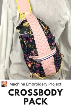 the machine embroidery project cross body pack is on display in front of a white shirt