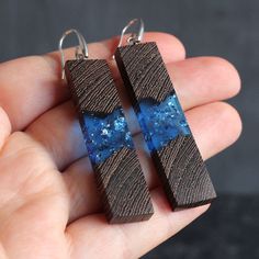 Stylish earrings made of wood and resin on silver clasp 925. This pair measures about 54 mm long and 13 mm wide. ► Your order will be packaged in a beautiful box, ideal for gifts, which is carefully packed in extra boxes for delivery. approximate delivery time takes 10-20 business days. ► Also look at all our wood resin jewelry - https://www.etsy.com/shop/SOGDbrand ► We also can produce our products under individual size and take into account all the wishes of the client. If you have any questio Handmade Natural Wood Earrings As Gift, Handmade Natural Wood Earrings For Gift, Elegant Natural Wood Jewelry For Gift, Wooden Anniversary Gift, Wood Resin Jewelry, Jewelry Casual, Resin Pendants, Earrings Wood, Casual Earrings