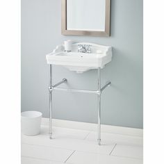 a white sink sitting under a mirror in a bathroom