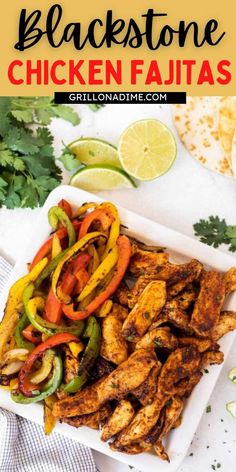 chicken fajitas on a white platter with limes and cilantro