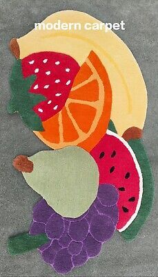 a close up of a rug with fruit on it