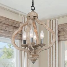 a wooden chandelier hanging from a ceiling