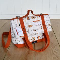 an orange and white bag sitting on top of a wooden floor