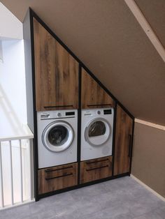 the washer and dryer are built into the side of the wall in this laundry room