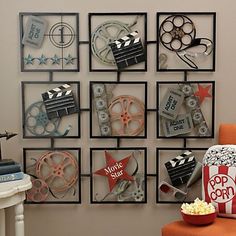 a movie themed wall hanging on the side of a wall next to an orange chair