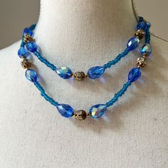 "Vintage Double Strand Faceted Royal Blue Crystal Glass Spacers Beaded Necklace One of the prettiest blue necklaces in my collection Faceted aurora borealis teardrop shape beads in 3 different sizes, separated by glass beads and accentuated with brass filigree beads with clear rhinestones in the middle Even a lock is truly exceptional! Longest strand drops down to approximately 18\", shorter strand is about 15\"-16\" Very good vintage condition with minor signs of wear and aging" Blue Necklaces, Brass Filigree, Double Ring, Blue Necklace, Multi Strand Necklace, Strand Necklace, Clear Rhinestones, Aurora Borealis, Blue Crystals