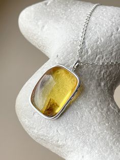 This stylish sterling silver pendant with a natural amber stone is sure to delight. Crafted from high-quality silver and featuring an 19-inch length chain, this jewelry piece is perfect for adding a touch of sophistication to your look. Natural Amber, Amber Stone, Amber Jewelry, Sterling Silver Pendant, Timeless Beauty, Sterling Silver Pendants, Silver Pendant, Jewelry Pieces, Amber