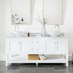 two sinks in a white bathroom with mirrors above them and a rug on the floor