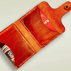 an orange leather wallet with a credit card holder