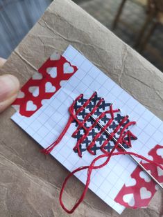 someone is making something with red, white and blue fabric on paper that looks like hearts