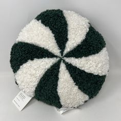 a green and white round cushion with a price tag on the bottom that says,