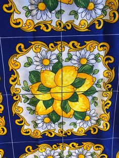 some yellow and white tiles with flowers on them