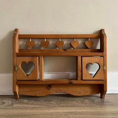 a wooden shelf with hearts cut out of it