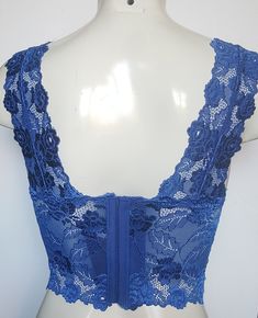 Hand decorated sleeveless lace crop top in Royal Blue color with floral pattern beading with matching sequins and beads. 1. Perfect for any occasion. 2. Available in 4 sizes XS, S, M, and L. 3. Has three rows of hooks-eye closure at the back. 4. Made from stretch lace which helps you adjust to your body size. 5. Individually hand beaded. 6. Light in weight and comfortable. 7. Has cotton lining in the inner bust area to block transparency. 8. Free USPS First Class shipping within the USA. Shippin Lace Crop Top With Built-in Bra, Fitted Cami Dress With Built-in Bra, Fitted Crop Top With Built-in Bra For Party, V-neck Lace Crop Top With Lace Trim, Summer V-neck Lace Top For Night Out, Cropped Top With Built-in Bra And Fitted Bodice, Chic Summer Lace Top With Built-in Bra, Fitted Cropped Crop Top With Built-in Bra, Spring Lace Dresses With Built-in Bra