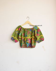 HarmonyHandicraftCo represent you a beautiful Banjara Top. Make your look more stylish by wearing this Banjara top.  Hand embroidery top with inside lining fabric. Banjara Top, Hand Embroidery Top, Indian Style Top, Indian Handmade Top, Banjara Kuchi Top, Hand Embroidery Choli, Banjara Choli. MEASUREMENTS :  Length - 17.5 Inches Chest - 42 Inches Inside lining Fabric FABRIC 100 % Hand Embroidered Could be used for Party, Birthday , Vacations Etc. Selling it at unbeatable price!! Wash Care - Mach Summer Multicolor Choli With Floral Embroidery, Summer Floral Embroidered Multicolor Choli, Summer Multicolor Floral Embroidered Choli, Summer Floral Embroidery Multicolor Choli, Traditional Multicolor Cotton Embroidered Top, Bohemian Unstitched Blouse Tops For Navratri, Bohemian Unstitched Blouse For Navratri, Festival Multicolor Choli With Floral Embroidery, Festival Multicolor Floral Embroidery Choli