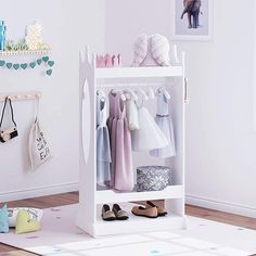 a child's closet with clothes and shoes