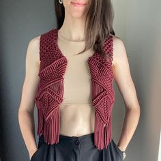 in bohemian elegance with handmade macrame vest. This festival top exudes country style, making it the perfect cowgirl outfit for your next party. The vibrant red hue adds a bold touch to the boho aesthetic, making it an ideal choice for a standout festival look. Crafted with care, this vest is not just an outfit but a statement piece, embodying the free-spirited essence of bohemian fashion. Information: * Material: polyester cord. * Color: red - ready to ship.  * Size: s-m * Handmade by myself in Lithuania, Europe. * Size s-m in red is ready to ship. For other sizes or other colors - please contact me by messages here on Etsy.  Care recommendations: hand-wash only with soup, no tumble dry, lay the garment out to dry on the flat surface, like a sofa, table or countertop. Shipping: ready to Macrame Vest Outfit, Sleeveless Fall Festival Top, Red Bohemian Crochet Top For Spring, Fitted Fringe Vest For Festival, Fitted Fringe Vest For Festivals, Sleeveless Vest For Fall Festival, Bohemian Vest Tops For Fall, Bohemian Fitted Vest For Festival, Bohemian Sleeveless Tops For Fall