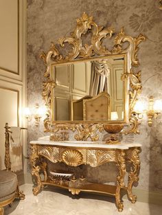 an ornately decorated bathroom with gold accents and marble counter tops, along with a mirror on the wall