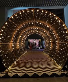 the entrance to an event decorated with lights