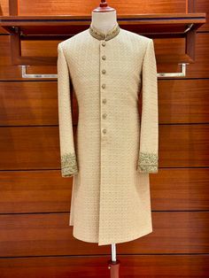 Presenting our exquisite golden embroidered karandi sherwani, a work of art created just for the groom on his wedding day. The gorgeous hand-stitched zardozi design embellishing the cuffs and ban is set off by a base of pure karandi. Our dedication to exceptional quality is evident in all the minute details. This sherwani's majestic atmosphere is enhanced by the tasteful vintage colour palette. Every piece is made to order and has a personalized touch. For the ideal fit, expect a measurement form and a call. Production takes 15-21 days, and then 3-6 days for quick shipping via FedEx or DHL. The sherwani and inner suit--which comes with your choice of shalwar, pant, or pajamas--are included in the bundle. Customize your outfit to your style; the choice is yours! Please be aware that because Semi-stitched Gold Kurta With Naqshi, Festival Gold Unstitched Suit With Naqshi Detail, Festive Raw Silk Gold Sherwani, Festive Gold Sherwani In Raw Silk, Gold Raw Silk Sherwani With Zari Work, Gold Jamawar Sets For Reception, Gold Kurta For Festivals And Receptions, Gold Kurta For Festive Events, Festive Gold Kurta With Naqshi Detail