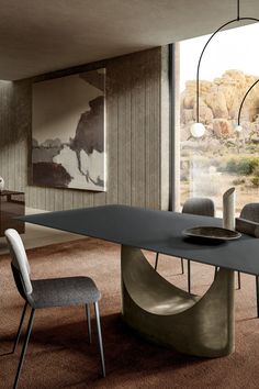 a modern dining table with two chairs around it