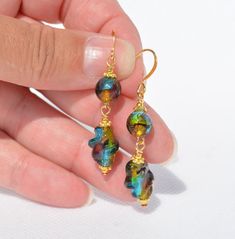 Venetian Style Glass / Murano Style Glass Earrings - Fun colors! (1)  Venetian Glass Foil earrings (22) -  8mm round and 14x8mm twist - gold-plated ear wire - Overall earring length is 2 inches (2)  Venetian Glass Foil earrings (23) -  8mm round and antiqued copper hammered link - antiqued copper  ear wire - Overall earring length is 1.85 inches (3)  Venetian Glass Foil earrings (24) -  8mm round and antiqued copper hammered link - antiqued copper  ear wire - Overall earring length is 1.85 inches (4)  Venetian Glass Foil earrings (25) -  8mm round and antiqued copper hammered link - XL copper  ear wire - Overall earring length is 2 inches (5)  Venetian Glass Foil earrings (26) -  8mm round - gold-plated ear wire - Overall earring length is 1.2 inches (6)  Venetian Glass Foil earrings (27) Glass Drop Earrings With Lever Back Ear Wires, Glass Dangle Earrings For Pierced Ears, Elegant Glass Dangle Earrings, Unique Gold Glass Earrings, Unique Glass Dangle Earrings, Multicolor Glass Drop Earrings, Gold Glass Earrings For Pierced Ears, Earrings Diy Handmade, Earrings Multiple