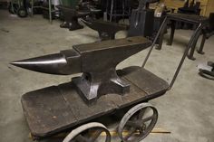 an old metal object on wheels in a shop