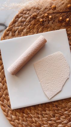 a white plate topped with a piece of bread next to a rolled up paper towel