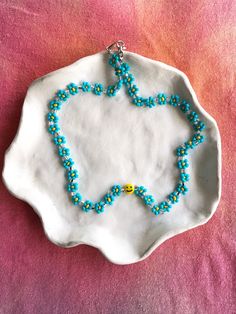 The 90s called, they approve of this colorful beaded daisy smiley necklace that is perfect on its own or layered with another necklace! 🌼🌸 This handmade beaded necklace features turquoise, orange and silver beads and a smiley bead to top it off! 🙂Made with stainless steel beading wire. Length: 38cm (including the clasp and ring). If you need it a little longer, message me and I'll work something out! ✿ Jewelry Care 101 ✿ Avoid getting your necklace wet, keep away from perfume and store it in a cool dry place. Would not recommend wearing it to sleep. See you on the gram! @its_a.okay ︎ Trendy Turquoise Beaded Necklace, Trendy Beaded Necklace With Colorful Turquoise Beads, Trendy Turquoise Round Beaded Necklace, Trendy Turquoise Beaded Necklaces With Round Beads, Trendy Handmade Turquoise Beaded Necklaces, Trendy Turquoise Beaded Necklaces For Gifts, Trendy Turquoise Beaded Necklace For Gift, Trendy Turquoise Beaded Necklaces, Cute Blue Necklace With Colorful Beads