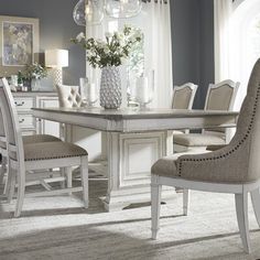 a dining room table with chairs and a chandelier