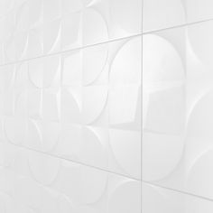 a white tiled wall with circles on it