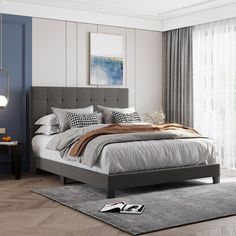 a bedroom with a large bed and gray walls