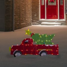 a red truck with a christmas tree on the back