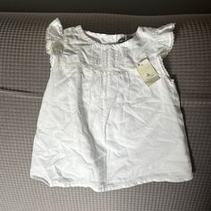 Girls White Gap Shirt Size 18-24 Months Nwt Gap Ruffled Short Sleeve Tops, Short Sleeve Ruffle Tops For Playwear, Fitted White Gap Top, White Fitted Top By Gap, Cute Summer Playwear Shirt, Cute Summer Blouse For Playtime, White Cotton Gap Top, Cute Summer Playtime Blouse, Gap Cotton Tops For Summer