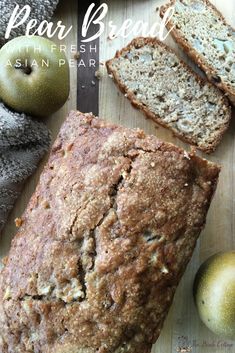 a loaf of bread sitting on top of a wooden cutting board next to an apple