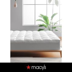 an image of a mattress in front of a window with the words macy's on it