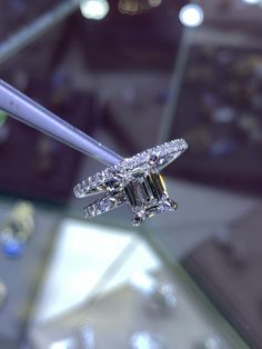 a diamond ring is being held by a woman's hand with a toothbrush