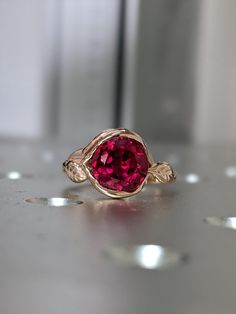 Ruby Ring, Ruby Engagement Ring Leaf Engagement Ring Rose Gold Ruby Ring, 2ct Ruby Engagement Ring, Leaves Ring, Leaf Ring, Nature Ring 14k rose gold Bijou ruby lotus flower ring, lotus engagement ring, leaf ring, vintage The central gemstone is beautifully framed by the petals of a lotus flower and cradled by delicate leaves in this unique vintage-inspired ring. Photos show 6.5mm option Piece Info: - 14K Rose Gold - Comfort Fit - Hypoallergenic, Cobalt-Free - Sleek Design - Durable - Comes in a Rose Gold Ruby Wedding Ring With Prong Setting, Red Ruby Ring In 14k Rose Gold, Ruby Ring In 14k Rose Gold With Round Shape, Rose Gold Ruby Jewelry With Prong Setting, Rose Gold Ruby Birthstone Ring For Promise, Pink Gold Ruby Ring, Rose Gold Ruby Ring With Lab-created Gemstone, Rose Gold Ruby Ring For Promise, Rose Gold Ruby Gemstone Promise Ring