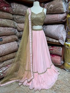 Featuring a millennial pink designer frill ruffle lehenga intricate with gotta lace, cut dana and mirror work lehenga. Completed look with contacting golden mirror, zari thread, stone and cut dana embroidered blouse and net dupatta. Fabric: Georgette This outfit can be customized in multiple colors and specific to client measurements. 120 days of production time is required and are for bulk orders only!Order are processed in store only! Final fittings/alterations not included. Minimum Order Quan Unstitched Pink Lehenga With Dori Work, Light Pink Choli Design, Unstitched Pink Lehenga With Dupatta, Pink Unstitched Lehenga With Embroidered Border, Pink Semi-stitched Choli With Cutdana, Pink Unstitched Lehenga With Cutdana, Ruffle Lehenga, Mirror Work Lehenga, Bridesmaid Lehenga