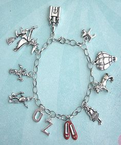 this charm bracelet features the wizard of Oz inspired tibetan silver charms -a silver plated zinc alloy metal which is lead and nickel free. each charm is attached to a silver tone bracelet that measures 7.5 inches in length. Themed Silver Metal Charms, Nickel Free Silver Themed Charms, Nickel-free Silver Themed Charms, Nickel-free Themed Silver Charms, Themed Silver Charm Bracelet, Themed Sterling Silver Charms, Themed Silver Sterling Charms, Silver Novelty Charm Bracelet, Silver Novelty Metal Charm Bracelet